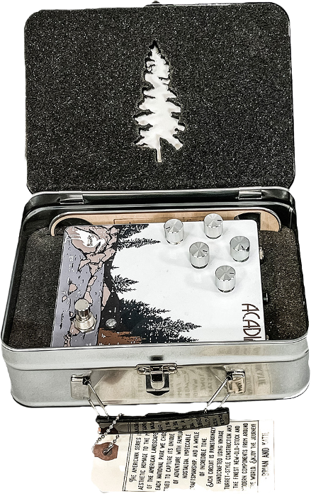 a tin box containing a guitar amp, surrounded by rigid foam