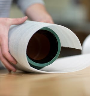 a person wrapping a product in a sheet of foam